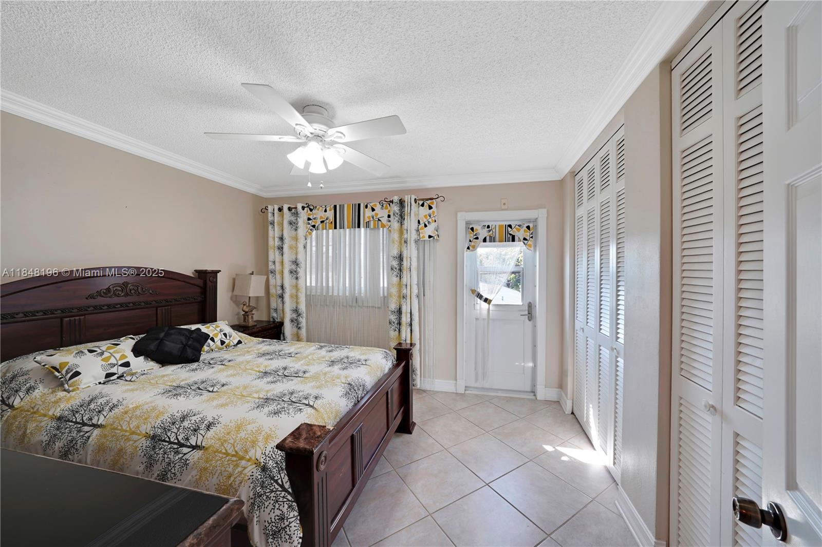 900 Atlantic Shores Boulevard, Unit 215 Hallandale Beach, FL 33009 - Photo 5 of 58 a bedroom with a bed and a chandelier