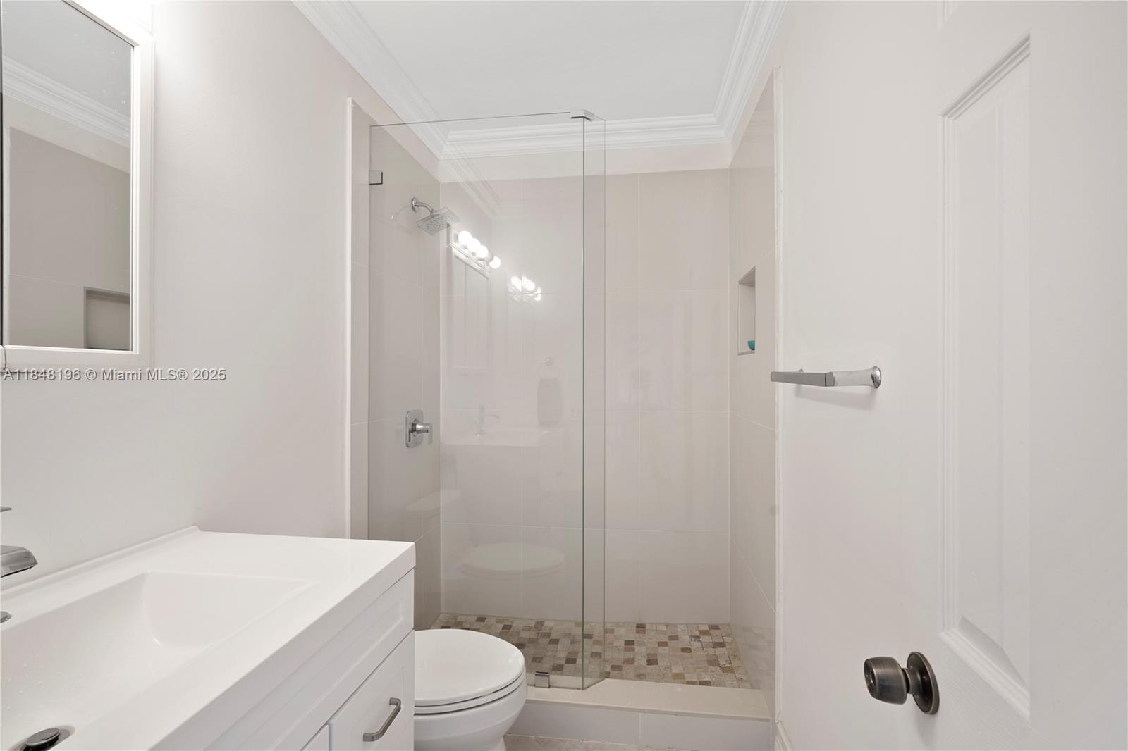 900 Atlantic Shores Boulevard, Unit 215 Hallandale Beach, FL 33009 - Photo 8 of 58 a bathroom with a sink a toilet and shower