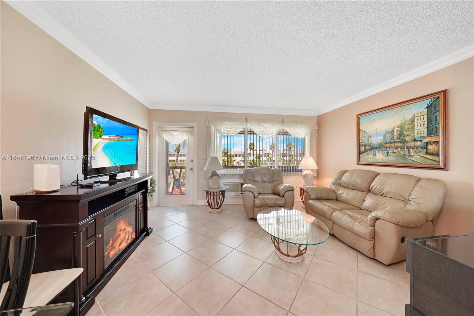 900 Atlantic Shores Boulevard, Unit 215 Hallandale Beach, FL 33009 - Photo 10 of 58 a living room with furniture a flat screen tv and a lamp