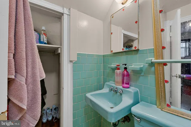 a bathroom with a sink toilet and mirror