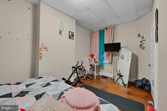 a room with furniture a flat screen tv and a window