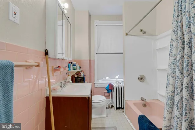 a bathroom with a sink a toilet and shower curtain