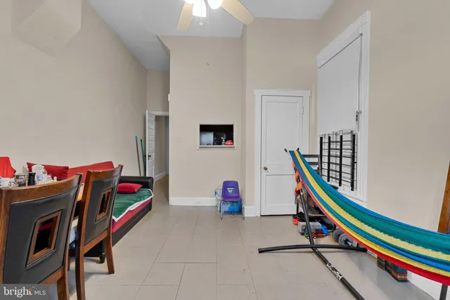 a living room with furniture and gym equipment