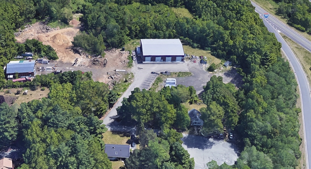 9 B Wellington Road Oxford, MA 01540 - Photo 4 of 6 an aerial view of a house with a yard and trees all around