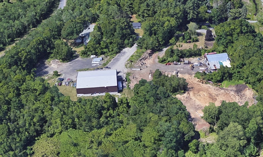 9 B Wellington Road Oxford, MA 01540 - Photo 5 of 6 an aerial view of a house with a yard and trees all around