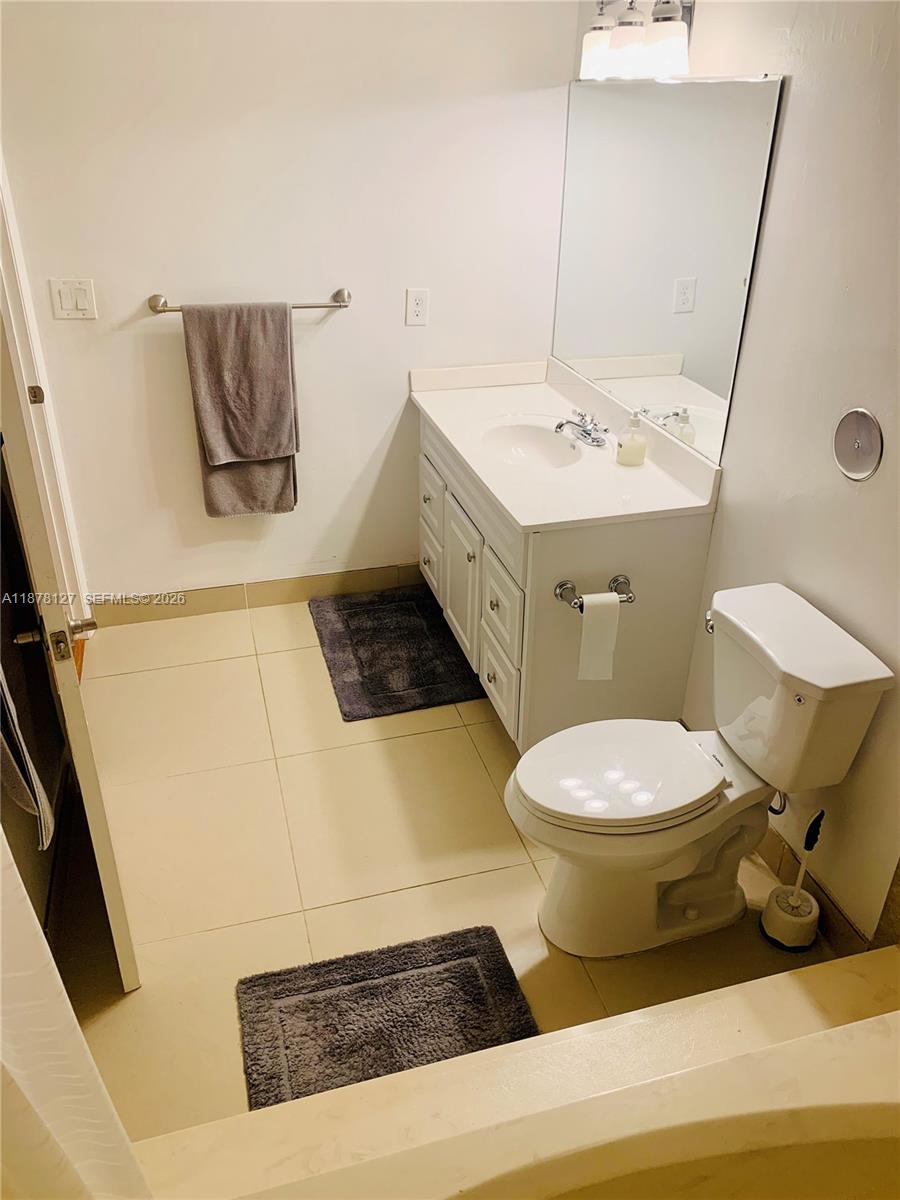 16500 Golf Club Road, Unit 101 Weston, FL 33326 - Photo 21 of 44 a bathroom with a sink and a mirror