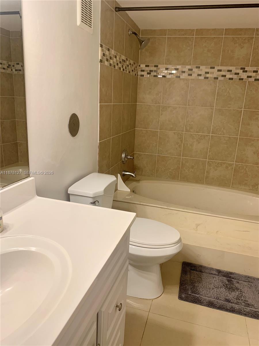 16500 Golf Club Road, Unit 101 Weston, FL 33326 - Photo 23 of 44 a bathroom with a sink a toilet and shower