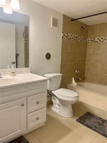 a bathroom with a toilet a sink a mirror a bathtub and shower