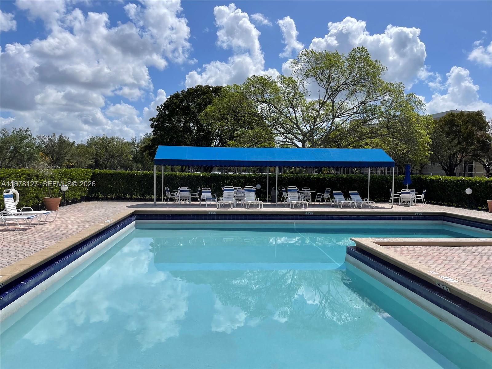 16500 Golf Club Road, Unit 101 Weston, FL 33326 - Photo 31 of 44 swimming pool with outdoor seating