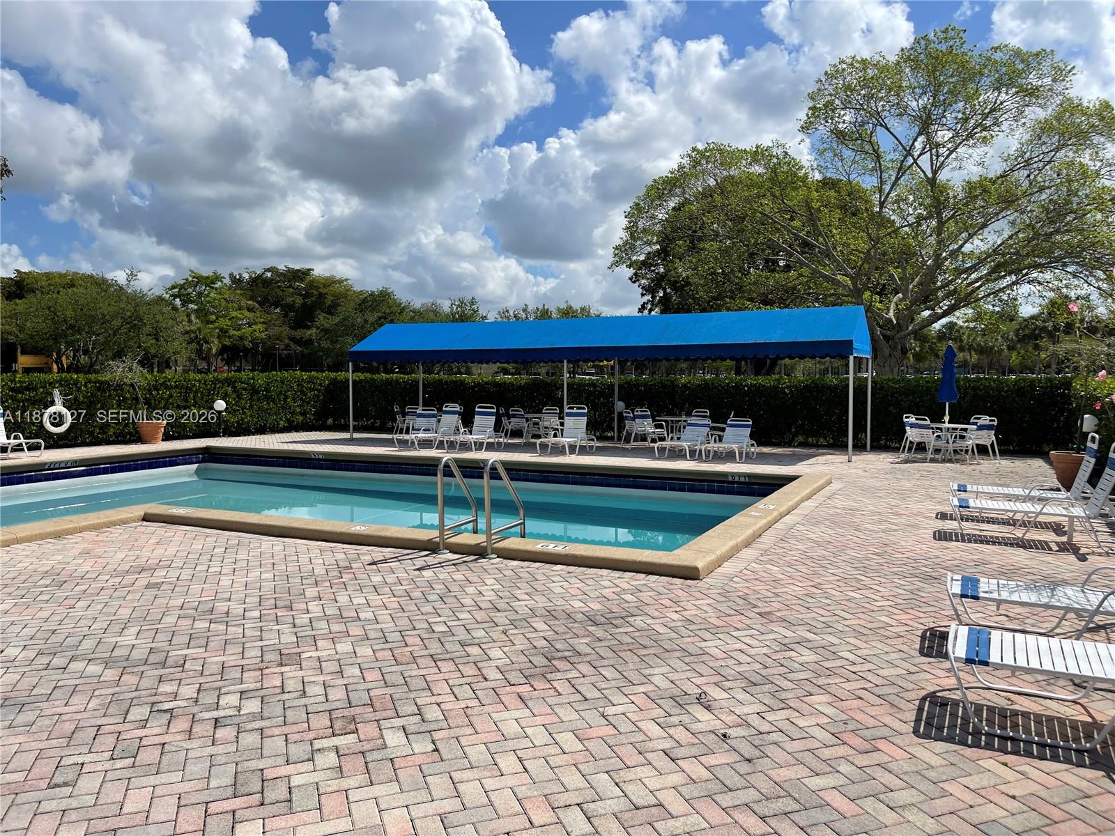16500 Golf Club Road, Unit 101 Weston, FL 33326 - Photo 32 of 44 swimming pool view with a seating space