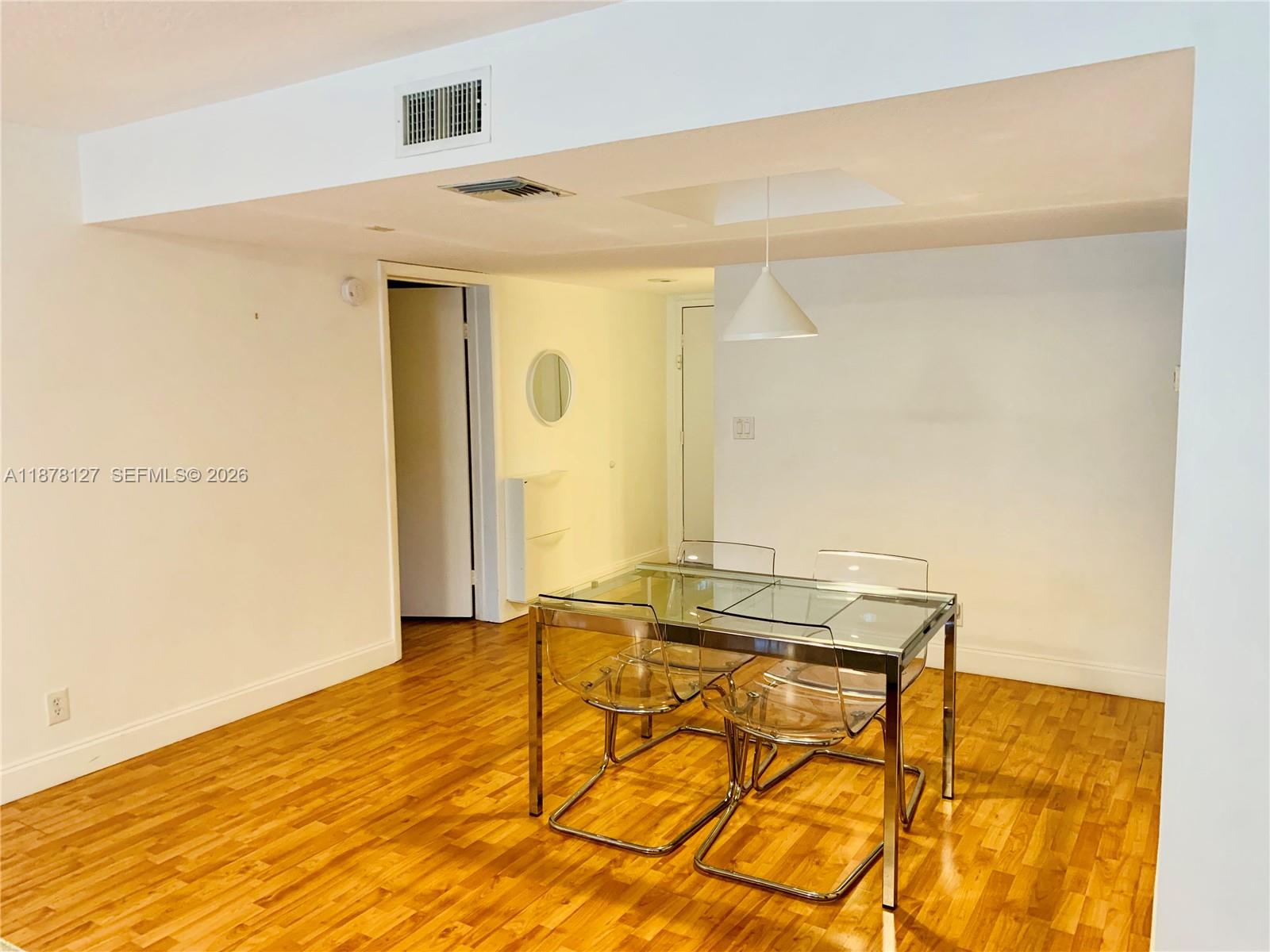 16500 Golf Club Road, Unit 101 Weston, FL 33326 - Photo 4 of 44 a view of a room with wooden floor and chair
