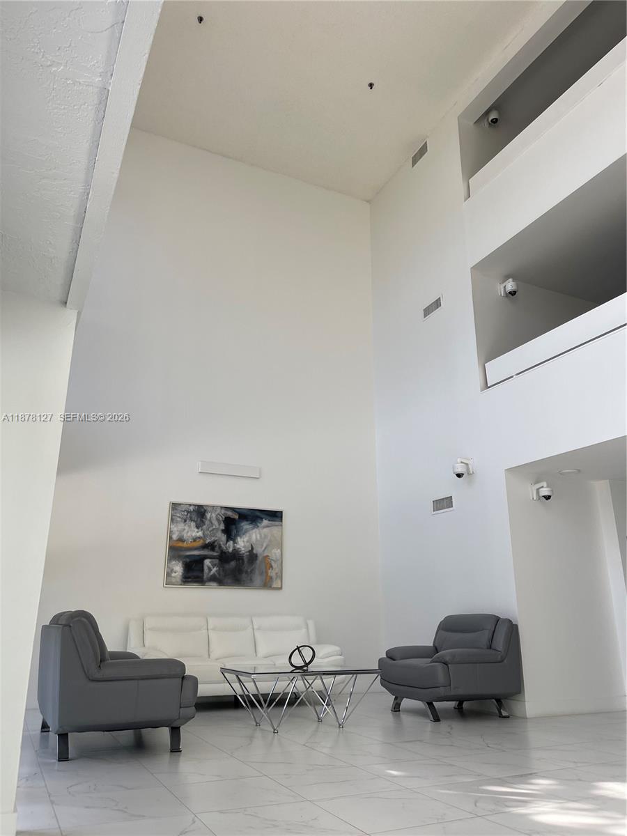 16500 Golf Club Road, Unit 101 Weston, FL 33326 - Photo 42 of 44 a living room with furniture and a flat screen tv