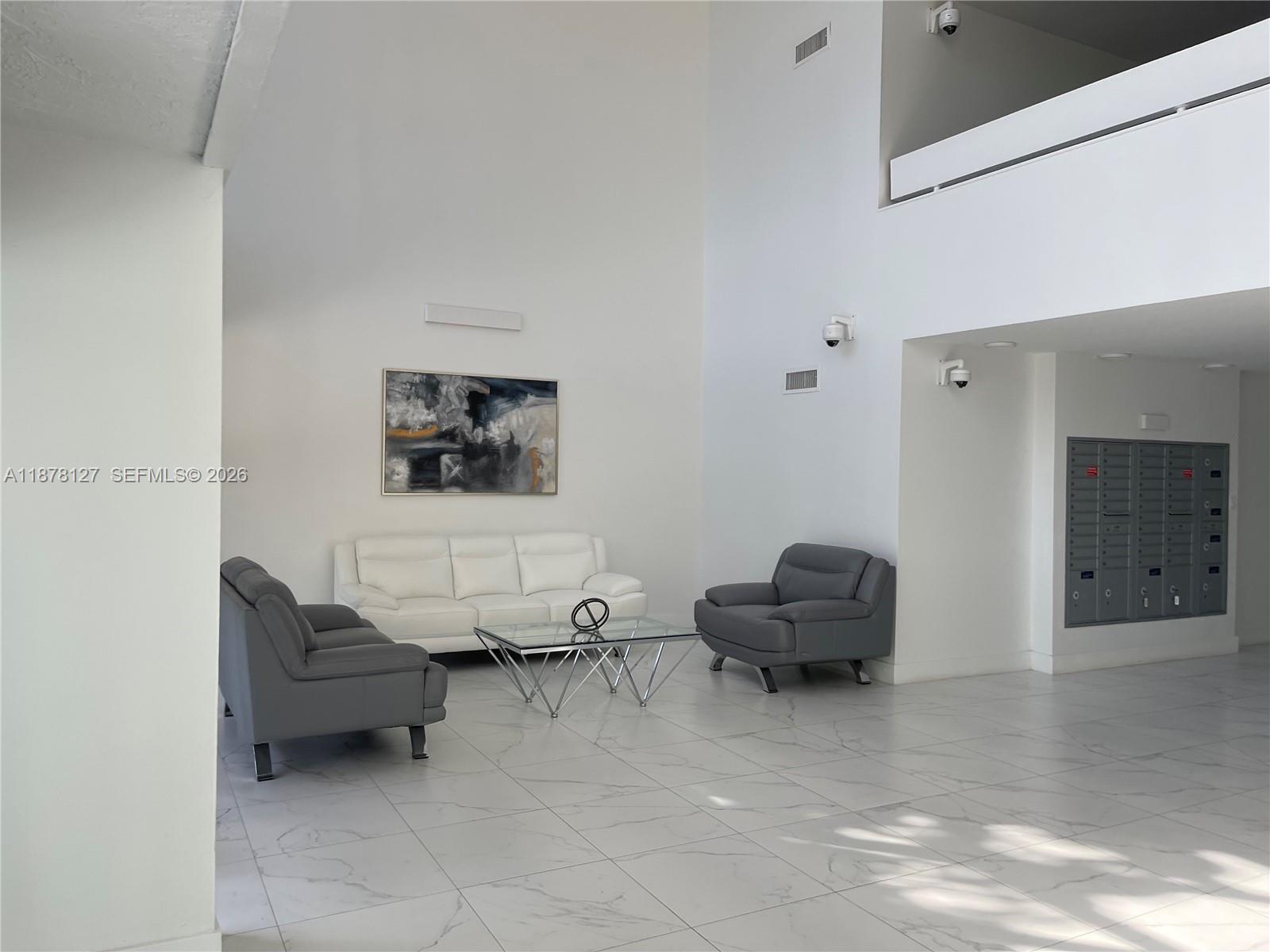 16500 Golf Club Road, Unit 101 Weston, FL 33326 - Photo 43 of 44 a living room with furniture and a mirror