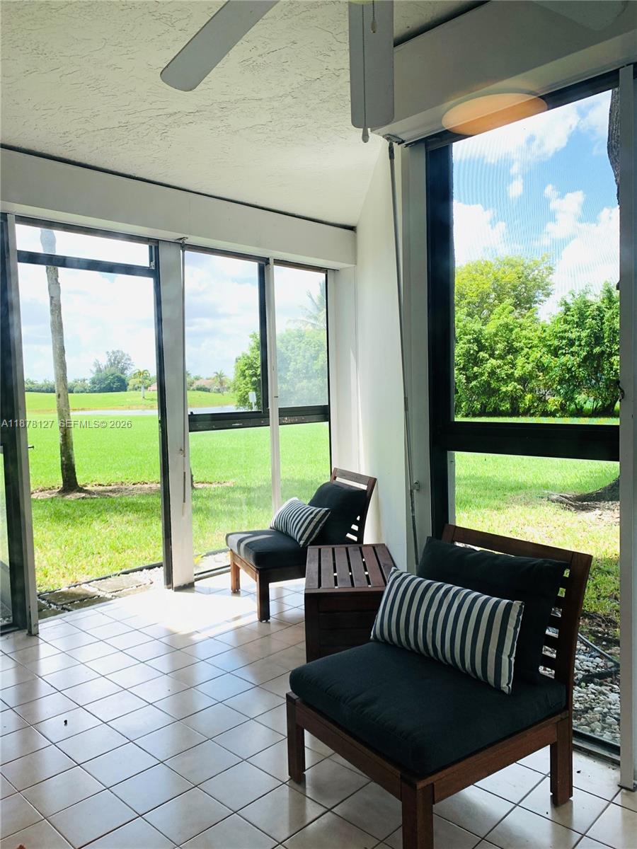 16500 Golf Club Road, Unit 101 Weston, FL 33326 - Photo 9 of 44 a view of a room with porch and furniture