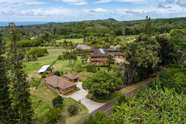 a living room with furniture stairs and a large window