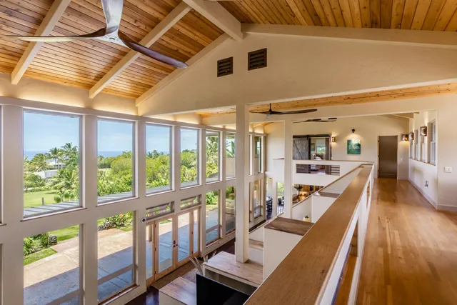 a view of empty room with furniture and windows