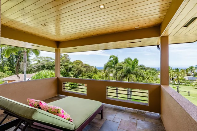 a view of a kitchen with kitchen island wooden floor and stainless steel appliances
