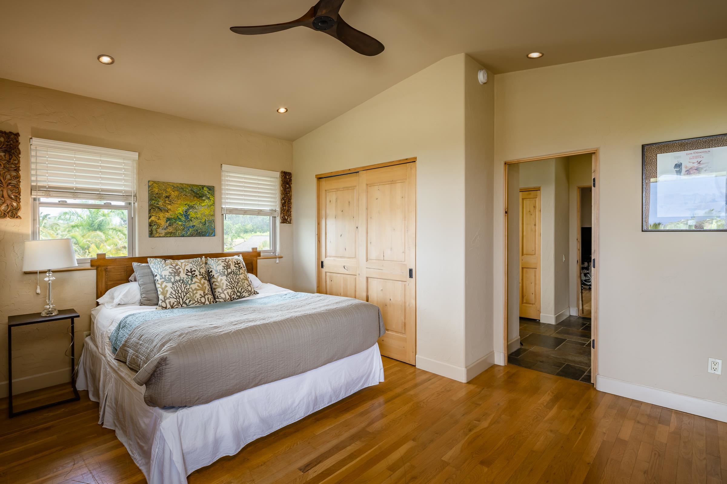 785 West Kuiaha Road Haiku, HI 96708 - Photo 25 of 49 a bedroom with a large bed and a chandelier