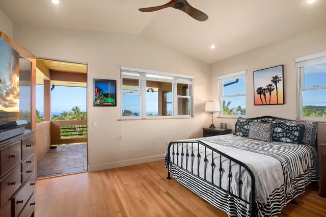 a living room with patio furniture and a garden