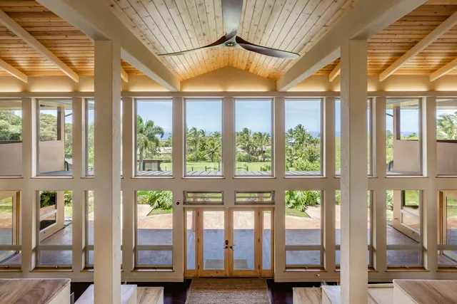 a view of a hallway with dining room and wooden floor
