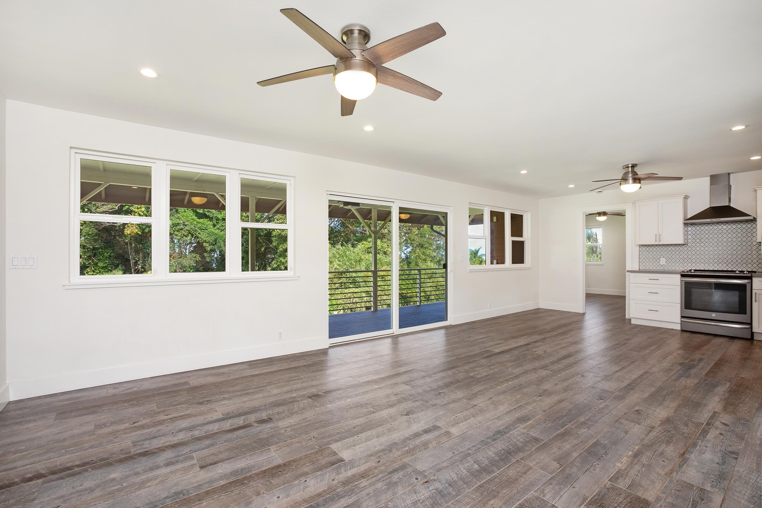 785 West Kuiaha Road Haiku, HI 96708 - Photo 42 of 49 a view of an empty room with a window and wooden floor