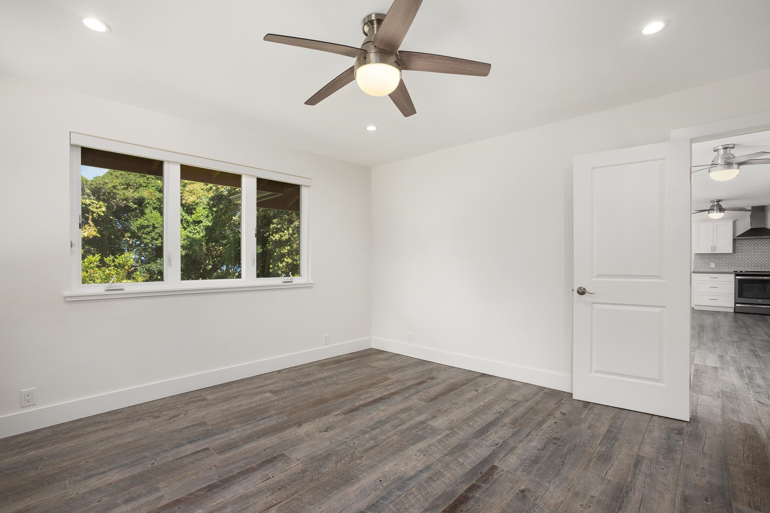 785 West Kuiaha Road Haiku, HI 96708 - Photo 44 of 49 a view of an empty room with wooden floor and a window