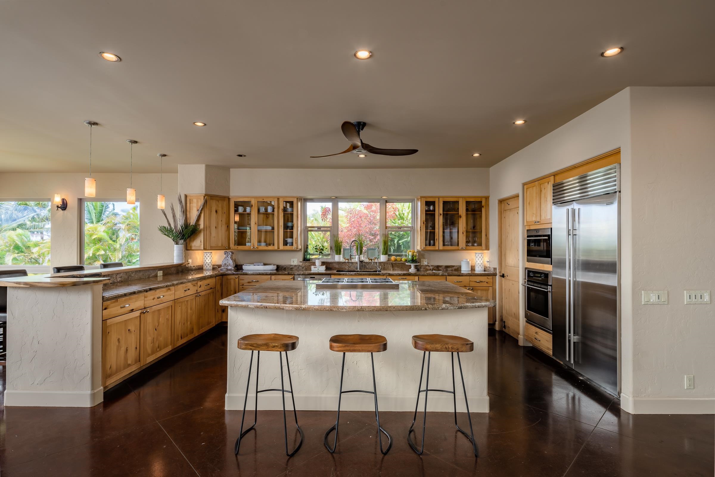 785 West Kuiaha Road Haiku, HI 96708 - Photo 8 of 49 a kitchen with stainless steel appliances granite countertop a stove and a refrigerator
