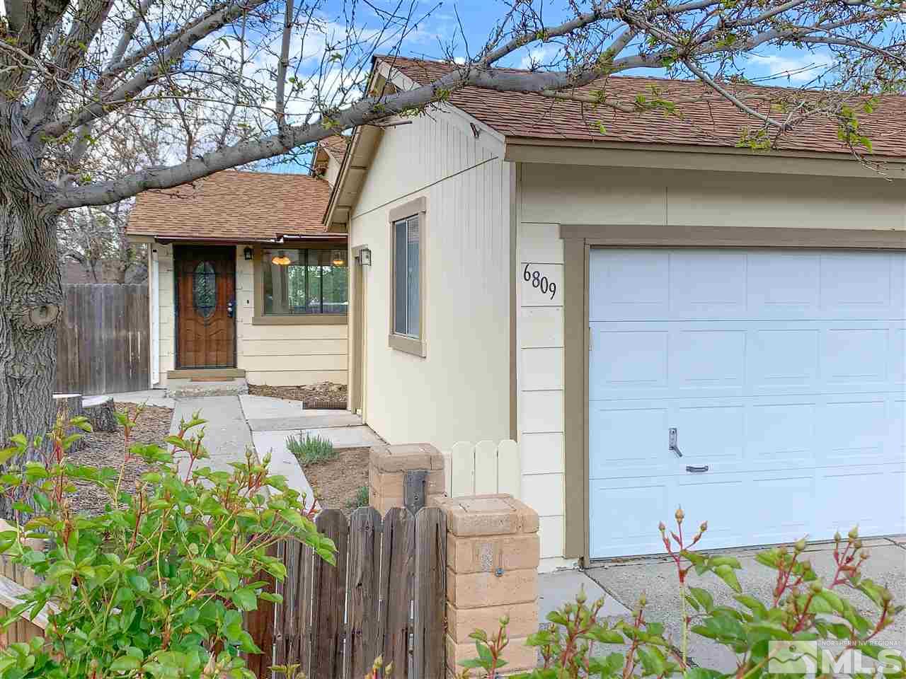 6809 Flower Street Reno, NV 89506 - Photo 1 of 15 a front view of a house with a yard
