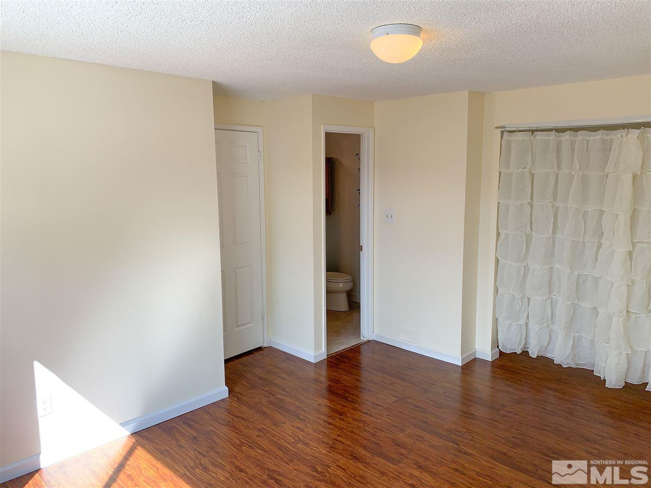 6809 Flower Street Reno, NV 89506 - Photo 11 of 15 a view of an empty room with wooden floor and a window