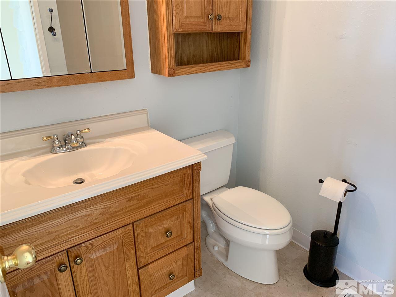 6809 Flower Street Reno, NV 89506 - Photo 12 of 15 a bathroom with a sink toilet and mirror