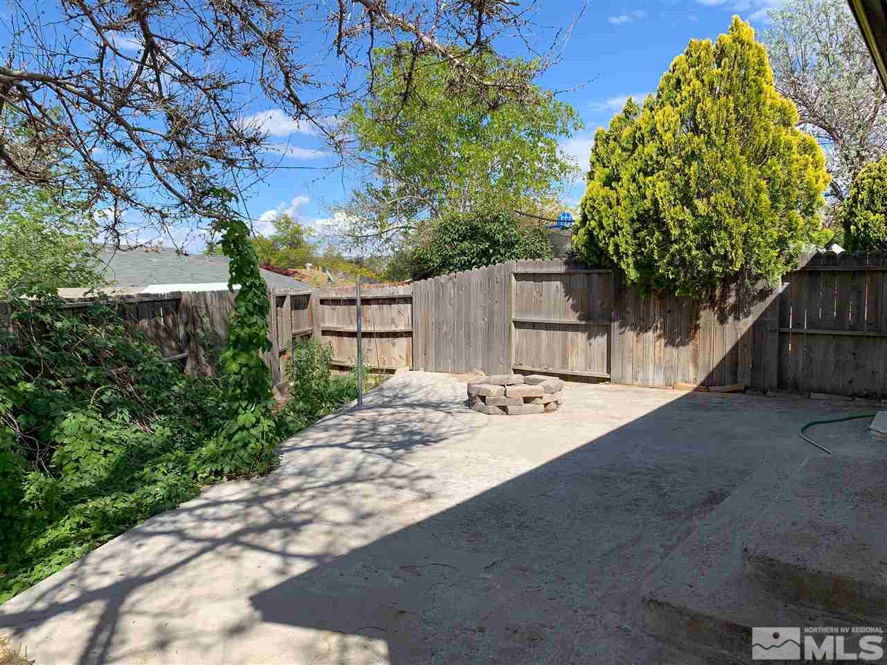 6809 Flower Street Reno, NV 89506 - Photo 13 of 15 a view of a backyard with plants and a large tree