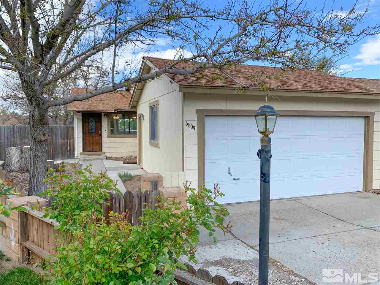 6809 Flower Street Reno, NV 89506 - Photo 15 of 15 a front view of a house with garden
