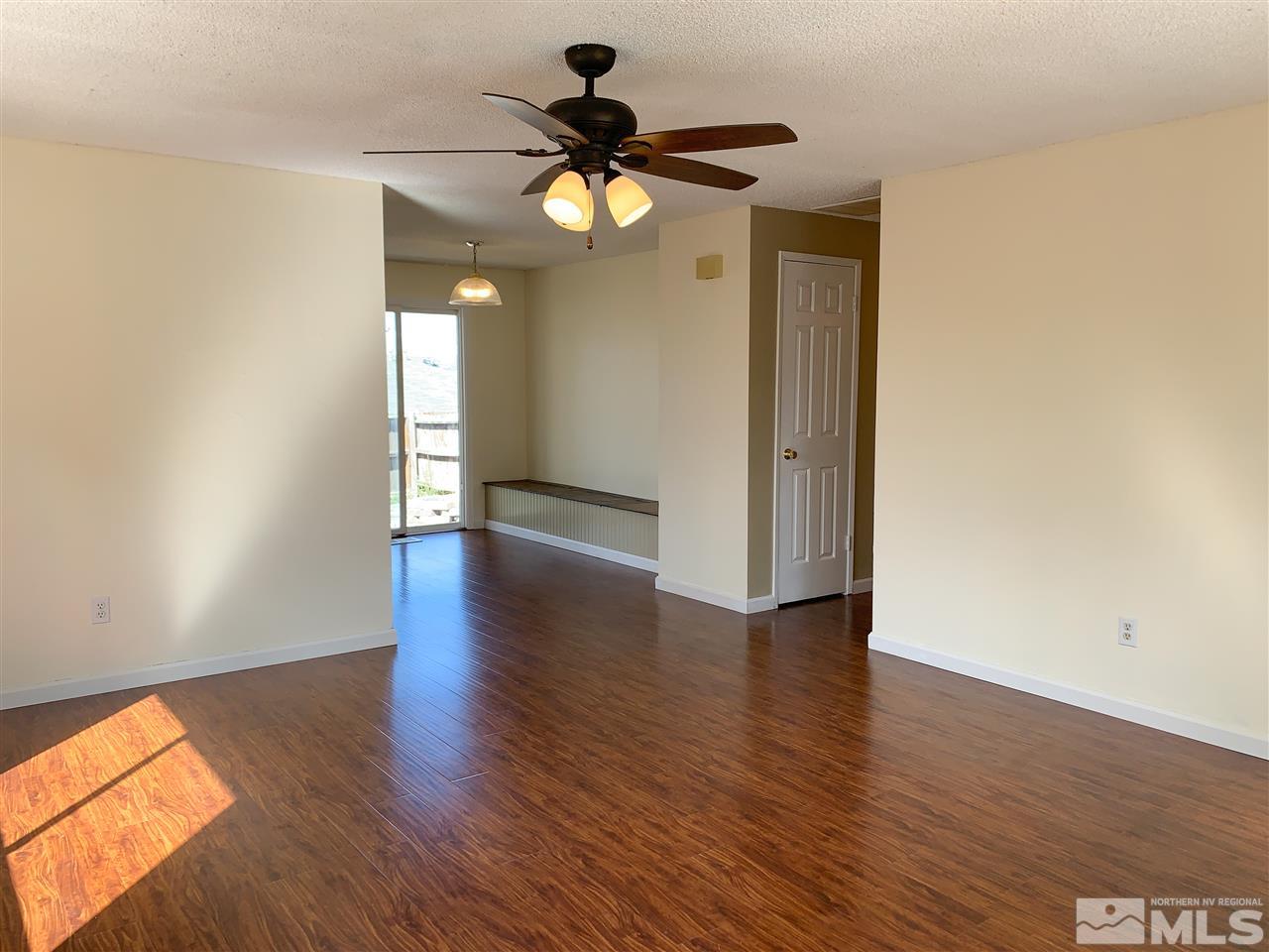 6809 Flower Street Reno, NV 89506 - Photo 2 of 15 a view of an empty room with wooden floor and a window
