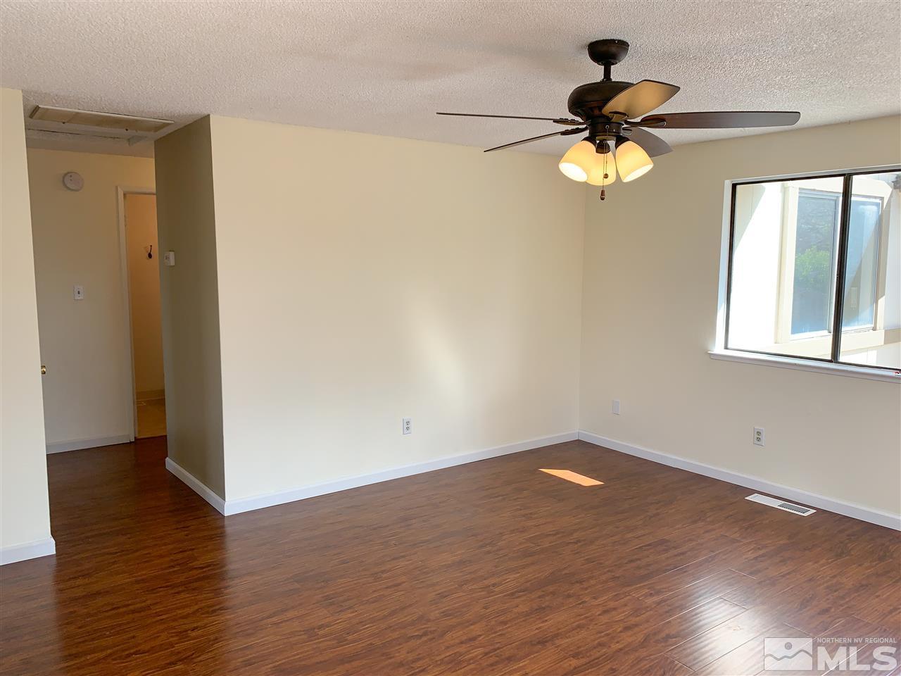 6809 Flower Street Reno, NV 89506 - Photo 3 of 15 a view of empty room with wooden floor and fan