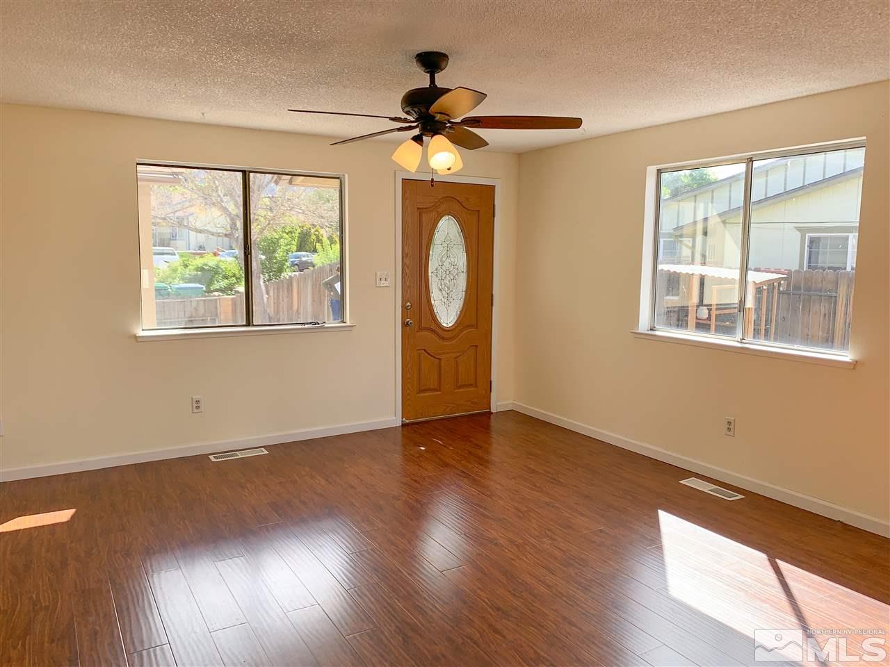 6809 Flower Street Reno, NV 89506 - Photo 4 of 15 a view of an empty room with wooden floor and a window