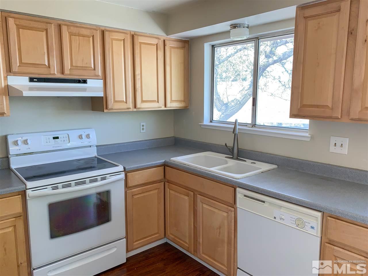 6809 Flower Street Reno, NV 89506 - Photo 5 of 15 a kitchen with appliances cabinets and a sink