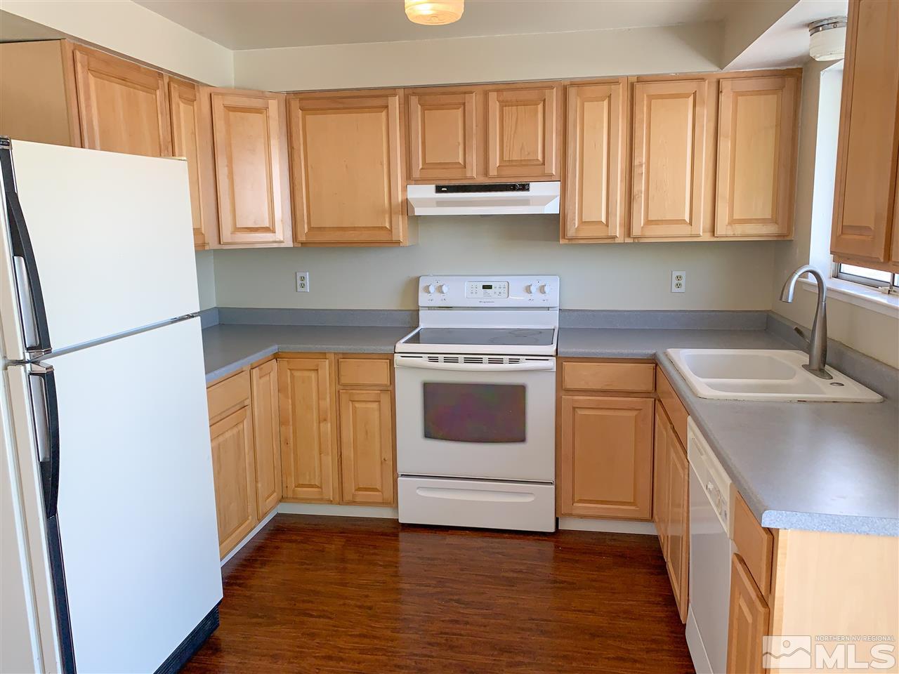 6809 Flower Street Reno, NV 89506 - Photo 6 of 15 a kitchen with a white stove top oven and refrigerator