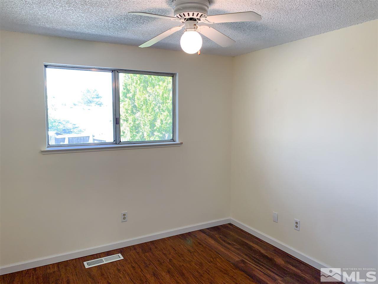 6809 Flower Street Reno, NV 89506 - Photo 8 of 15 an empty room with a window and a fan