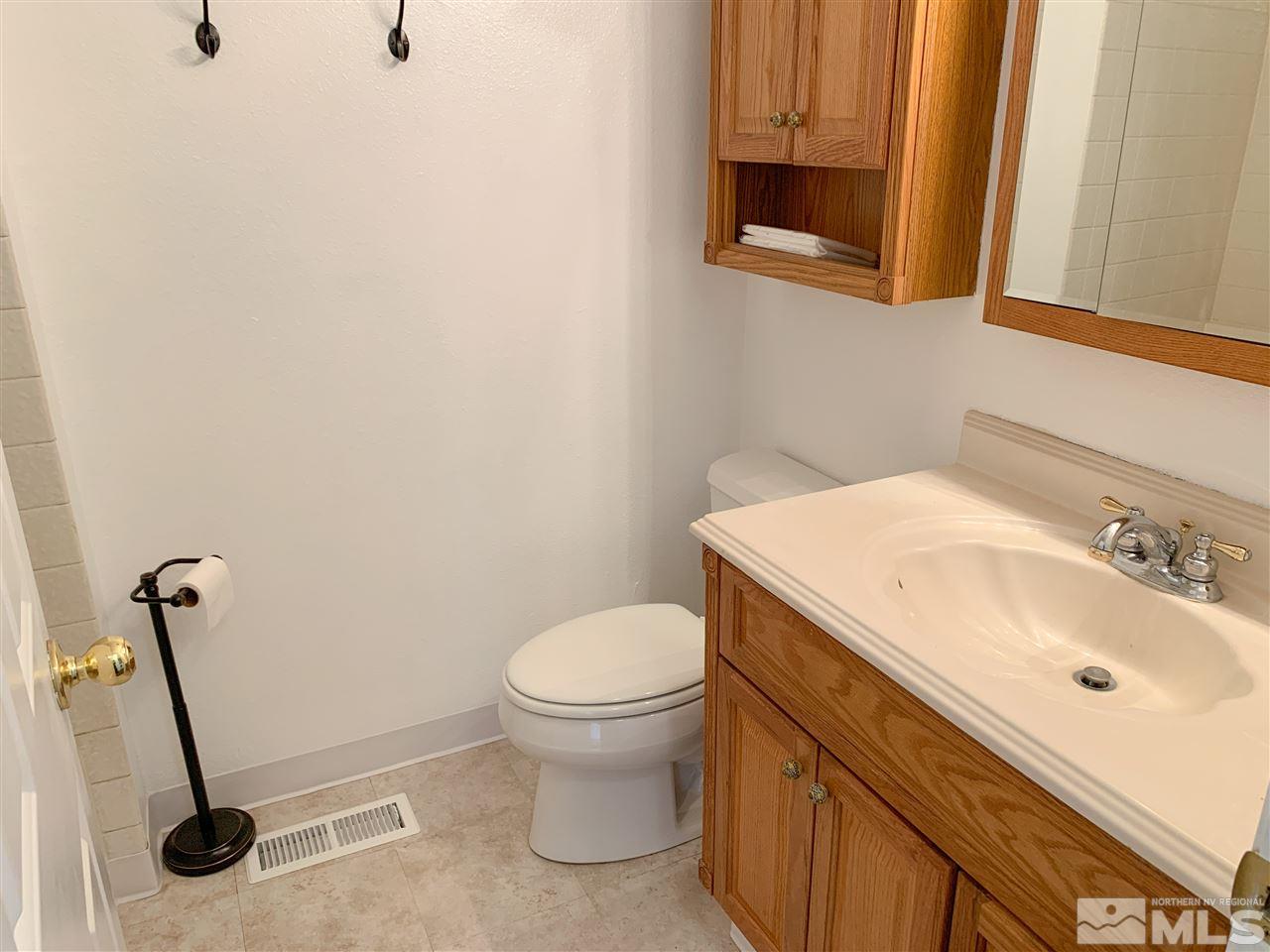 6809 Flower Street Reno, NV 89506 - Photo 9 of 15 a bathroom with a sink and a toilet