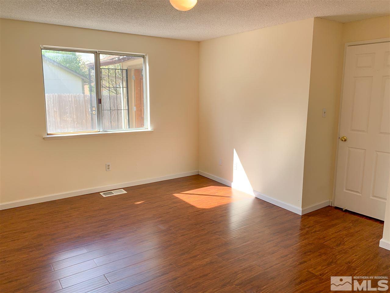 6809 Flower Street Reno, NV 89506 - Photo 10 of 15 a view of empty room with wooden floor and fan