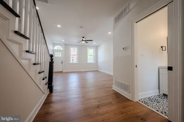 a view of an entryway with wooden floor and staircase