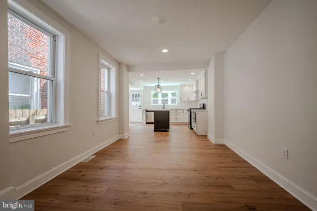a view of a kitchen with furniture and wooden floor