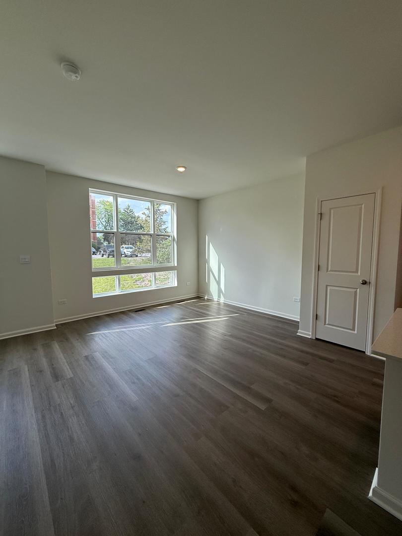 347 Summit Circle Lombard, IL 60148 - Photo 14 of 18 an empty room with wooden floor and windows