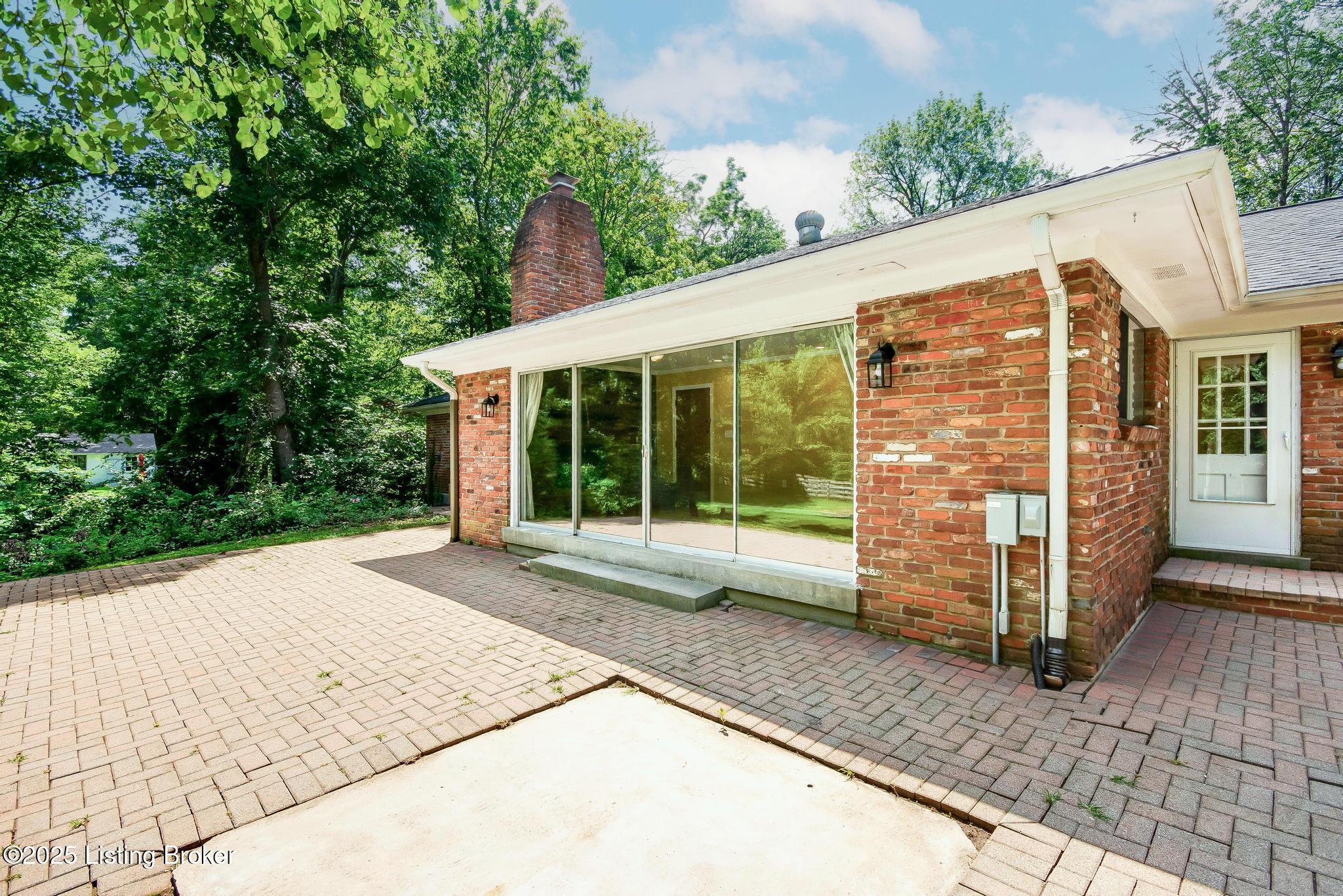 9611 Fairground Road Louisville, KY 40291 - Photo 39 of 57 Rear Patio with Sliding Glass Doors. There is an existing concrete pad that was used for a hot tub by the previous owner.