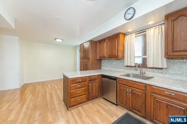a kitchen with a sink cabinets and window