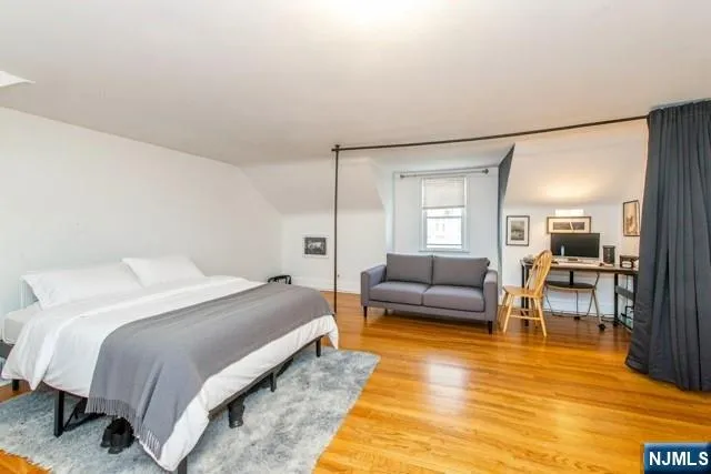 a spacious bedroom with a bed and a couch