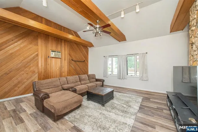 a living room with furniture and a rug