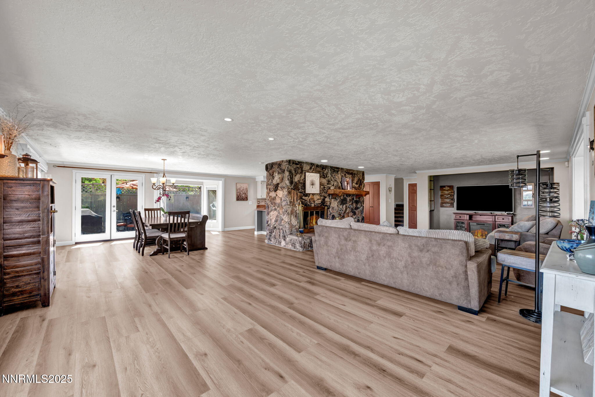 3495 West Plumb Lane Reno, NV 89509 - Photo 12 of 38 a living room with furniture and a flat screen tv with kitchen view