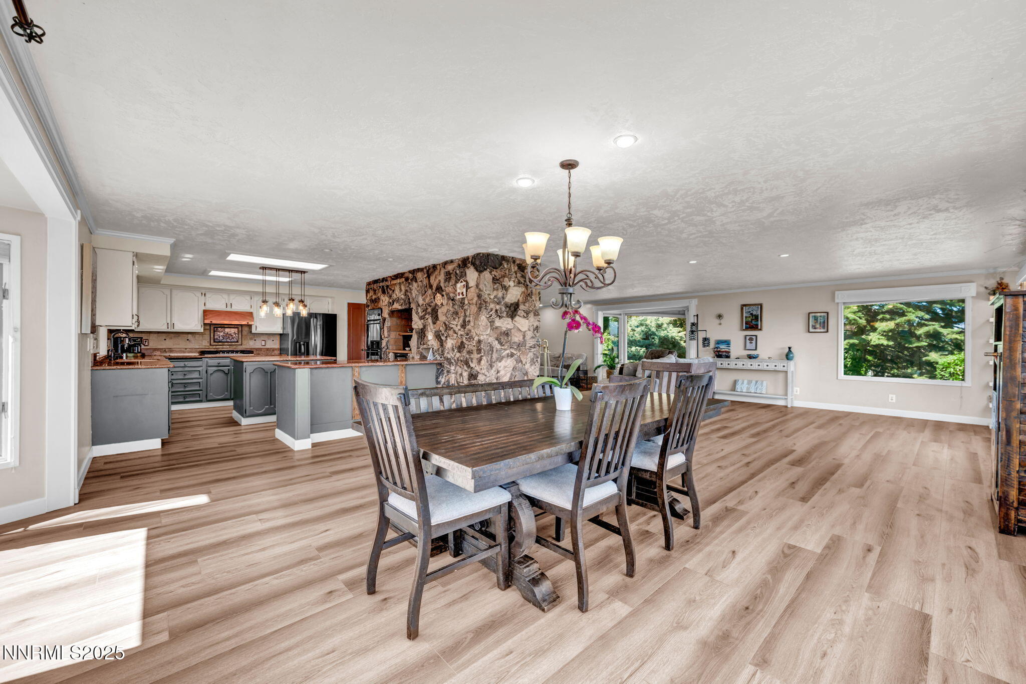 3495 West Plumb Lane Reno, NV 89509 - Photo 14 of 38 a view of a dining room with furniture wooden floor and chandelier