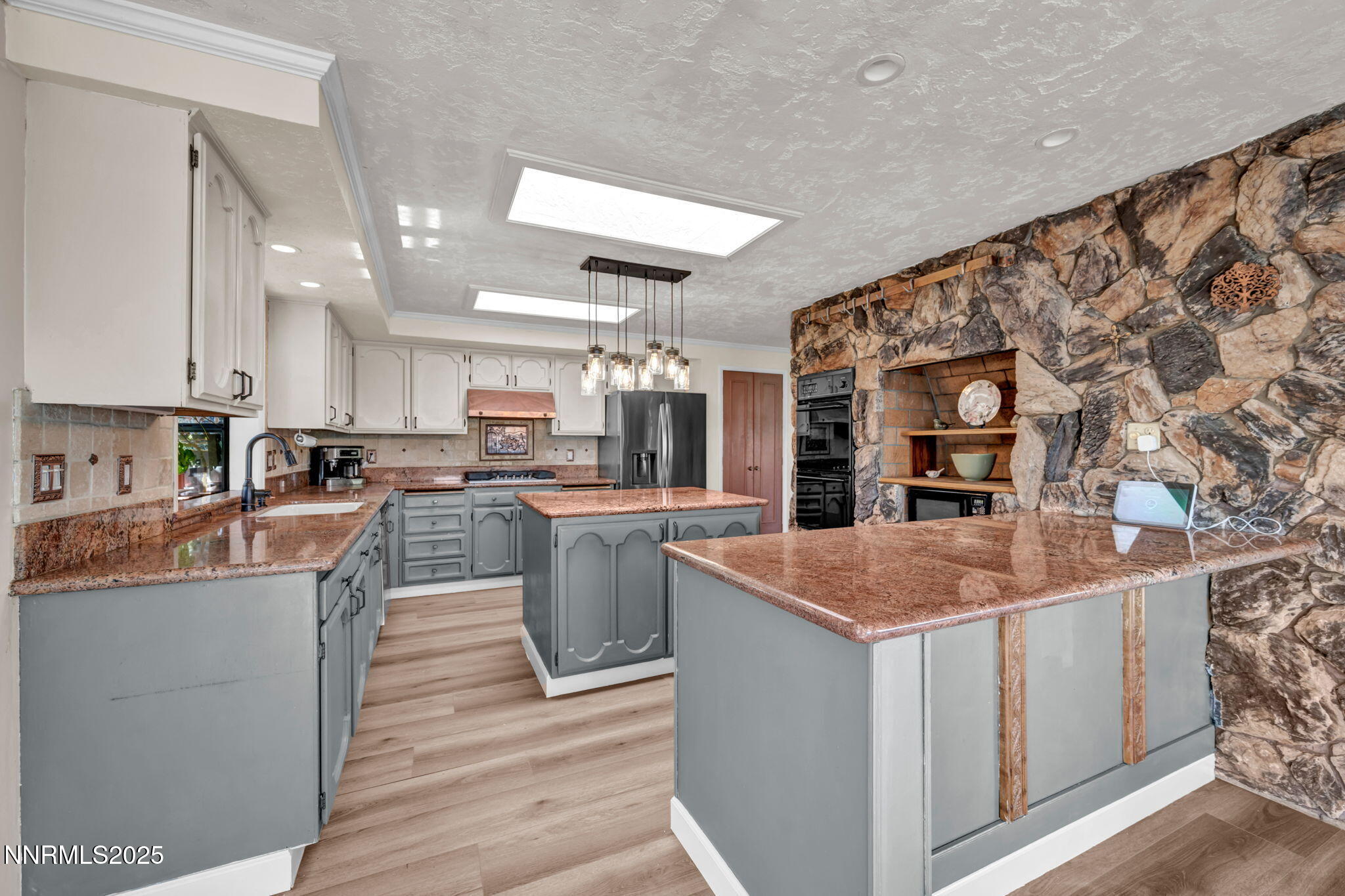 3495 West Plumb Lane Reno, NV 89509 - Photo 16 of 38 a kitchen with stainless steel appliances granite countertop a sink stove and cabinets